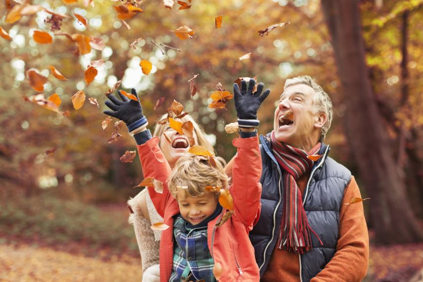 Family having fun with fall leaves