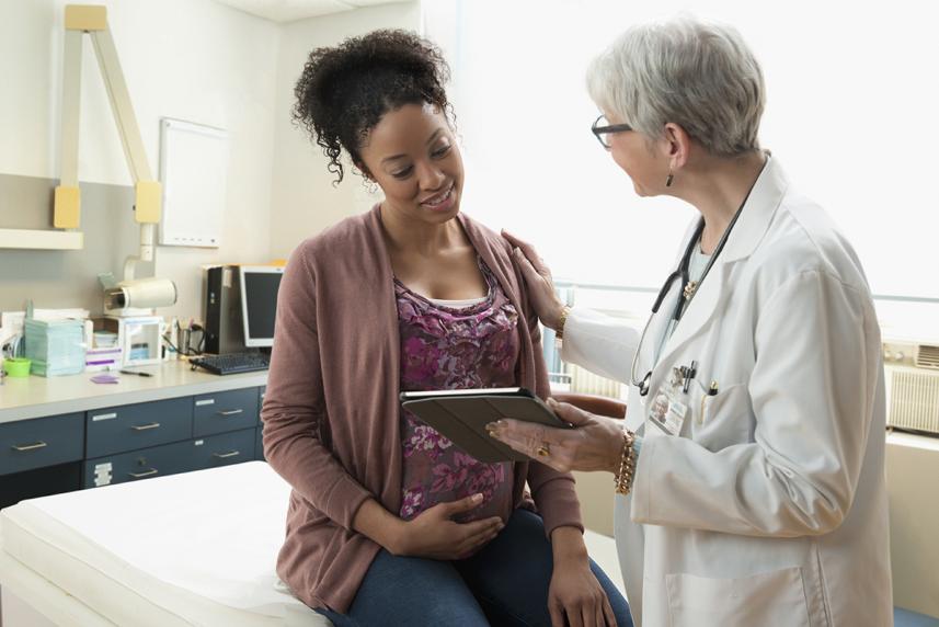 Pregnant woman talking with doctor