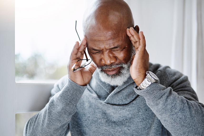 A older gentleman gets a stress-related headache.