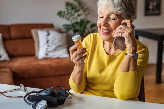 Elderly woman looking at her medication