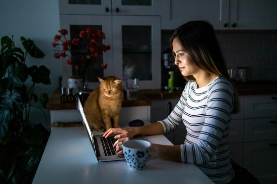 Woman on laptop with her cat